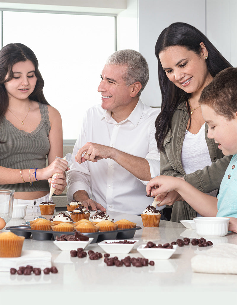 Green Sun founder and family preparing chocolate snacks together in the kitchen.