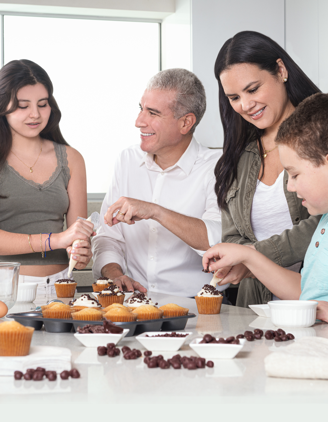 Green Sun founder and family preparing chocolate snacks together in the kitchen.