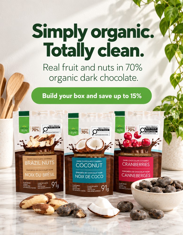 Simply organic, totally clean: Green Sun Brazil nut, coconut and cranberry pouches on a marble kitchen counter with a bowl of dark chocolate covered snacks